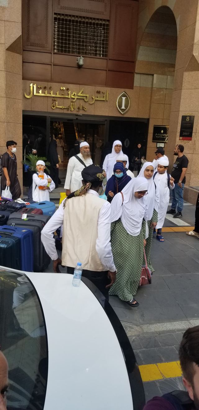 Amity travelers arriving with luggage at the entrance of the InterContinental Dar Al Iman hotel in Madinah