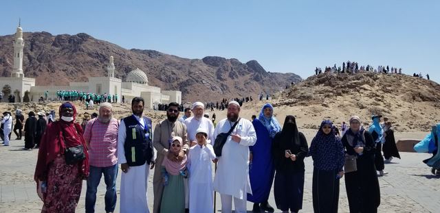 Amity Umrah group at Uhud, the Sayyid al-Shuhada Mosque and Archers' Hill behind